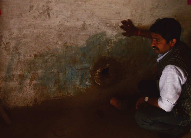 Pannalal, a local activist, checks out the family storage system